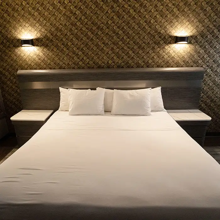 well-made bed in clean motel room in the Bronx, NY