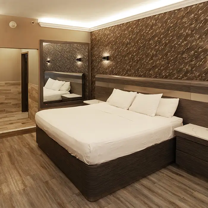 well-made bed in clean motel room in the Bronx, NY