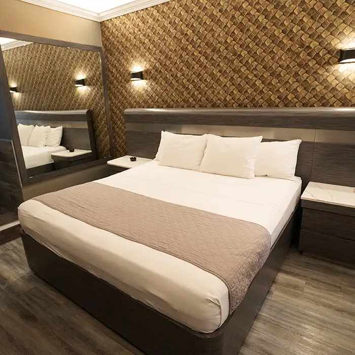 well-made bed in clean motel room in the Bronx, NY